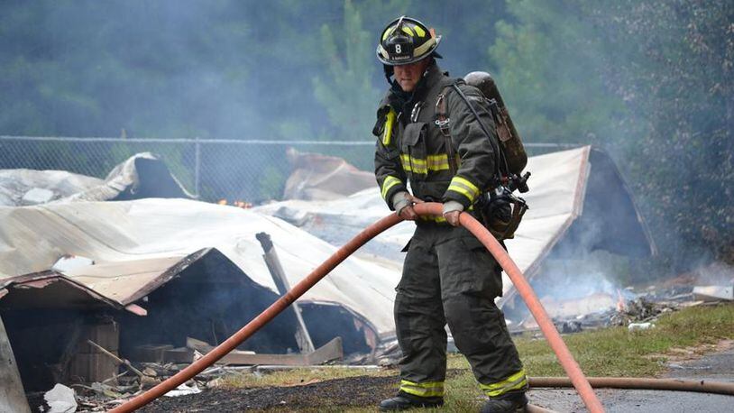 Cherokee County firefighters respond to a blaze possibly sparked by lightning. The county recently approved transferring fire hoses and other gear declared surplus to a volunteer department in Pickens County. TIM CAVENDER/CHEROKEE COUNTY FIRE & EMERGENCY SERVICES