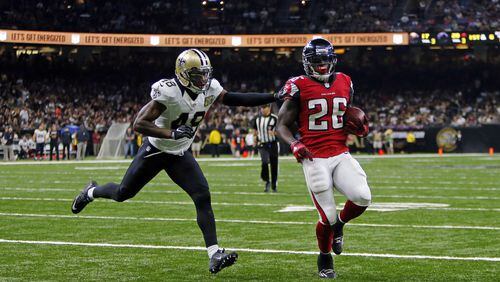 Atlanta Falcons running back Tevin Coleman (26) crosses into the end zone for a touchdown in front of New Orleans Saints free safety Vonn Bell (48) in the second half of an NFL football game in New Orleans, Monday, Sept. 26, 2016. (AP Photo/Butch Dill)