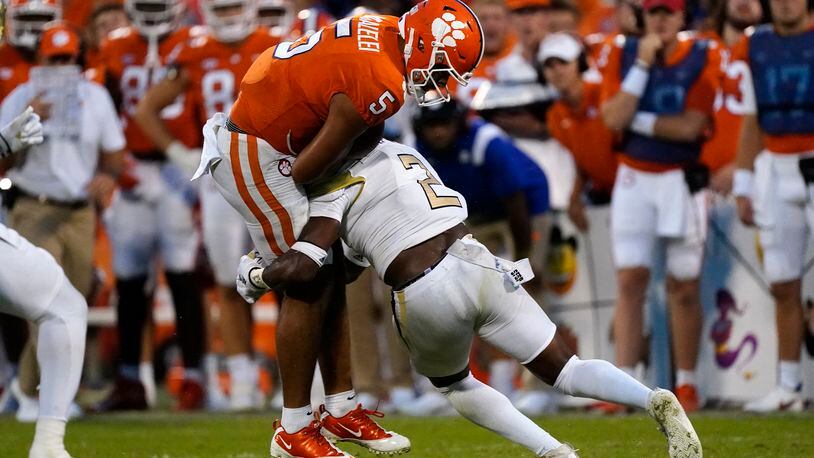 Clemson quarterback D.J. Uiagalelei (5) is hit by Georgia Tech defensive back Tariq Carpenter (2) after a short gain in the second half of an NCAA college football game, Saturday, Sept. 18, 2021, in Clemson, S.C. (AP Photo/John Bazemore)