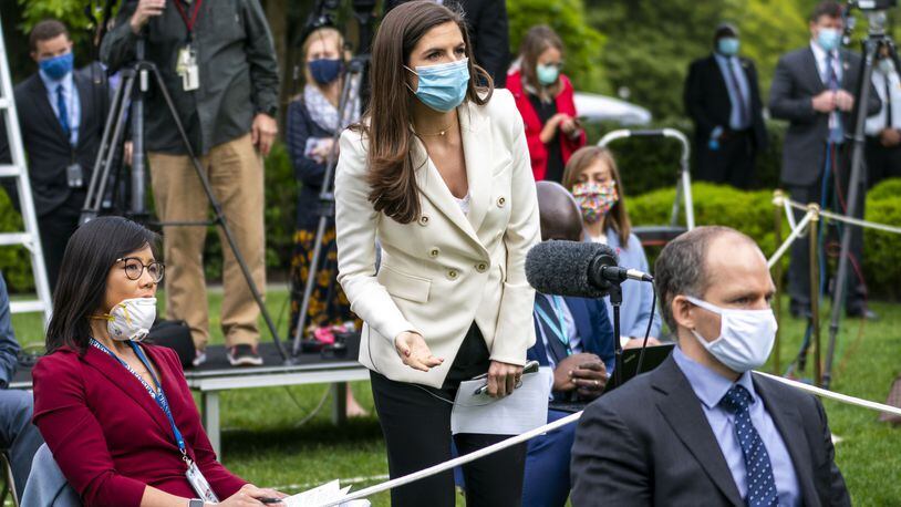 Kaitlan Collins of CNN attempts to ask a question of President Donald Trump when he abruptly ended his news conference about the coronavirus on May 11. Seated at left is Weijia Jiang of CBS News. DOUG MILLS / THE NEW YORK TIMES