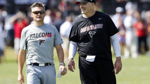 In this July 31, 2015, file photo, Atlanta Falcons head coach Dan Quinn, right, talks with general manager Thomas Dimitroff during training camp in Flowery Branch, Ga. (AP Photo/John Bazemore)