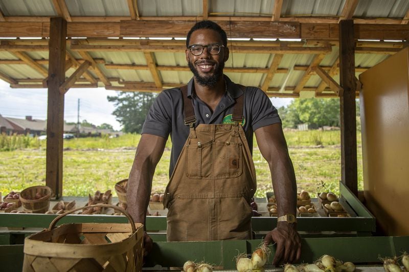 Atlanta Harvest Farms co-owner EliYahu Ysrael, 25, stands for a photo in the open-air market area at Atlanta Harvest Farms in Jonesboro. That will soon be moving to property in Ellenwood. ALYSSA POINTER / ALYSSA.POINTER@AJC.COM