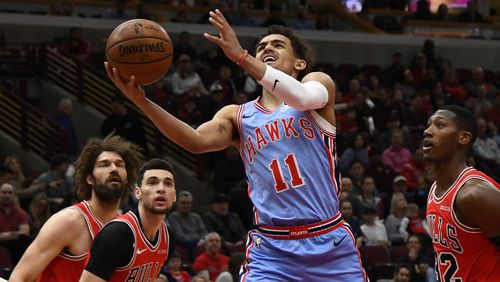 Atlanta Hawks guard Trae Young (11) shoots against Chicago Bulls guard Kris Dunn (32) during the first half Sunday, March. 3, 2019, in Chicago.