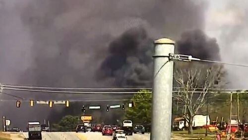 The blaze sent large plumes of black smoke over South Cobb Drive near Pat Mell and Austell roads.