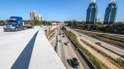 October 5, 2020 Atlanta: Traffic traveled across the new flyover ramp on Ga. 400 South at I-285 East for the first time on Monday Oct. 5, 2020.  First time motorists complained Monday about poor signage and expressed confusion to the WSB 24-hour Traffic Center.  Drivers on Ga. 400 southbound to I-285 eastbound will need to merge to the farthest right lane on Ga. 400 southbound and merge onto the ramp just before the Hammond Drive overpass. Drivers will travel on the over 80-foot tall ramp until it merges with I-285 eastbound just before the Perimeter Center Parkway overpass. GDOT officials say there are signs warning drivers of the changes before the new configuration. The new I-285 interchange at Ga. 400 north of Atlanta was supposed to be finished by the end of this year. Thanks to the discovery of unmarked utilities and the addition of work to the project, the new target date is late 2021, according to the Georgia Department of Transportation. It's the second delay for the $800 million project. (John Spink / John.Spink@ajc.com)

