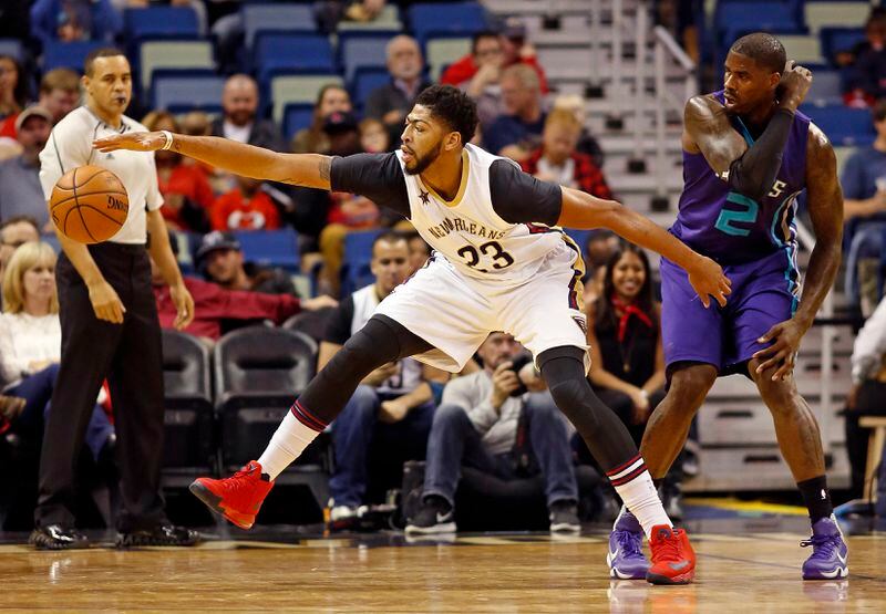 New Orleans Pelicans forward Anthony Davis (23) attempts to recover a lose ball against Charlotte Hornets forward Marvin Williams (2) during the first half of an NBA basketball game in New Orleans, Saturday, Nov. 19, 2016. (AP Photo/Max Becherer)