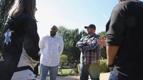 Hoschton City Council candidates Shantwon Astin (left) and Adam Ledbetter (right) talk to voters at a meet and greet Saturday, Nov. 2, 2019. Astin and Ledbetter, decided to run for office after an AJC investigation into racially divisive actions and comments by Mayor Theresa Kenerly and Mayor Pro Temp Jim Cleveland thrust the north metro city into the national limelight. CHRIS JOYNER / CJOYNER@AJC.COM
