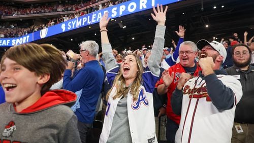 Braves fans react after beating the Phillies in Game 2 of the 2023 NLDS at Truist Park in Atlanta on Monday, October 9, 2023. (Arvin Temkar / arvin.temkar@ajc.com)