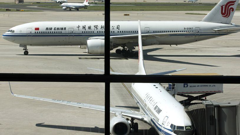 In this Sept. 5, 2013 file photo, an Air China’s Boeing 777 jet, top, taxis to a gate after landing at Beijing International Airport in Beijing, China. Air China said Thursday, Sept. 8, 2016, that it had removed copies of its inflight magazine containing an article telling visitors to take precautions when visiting areas of London with large ethnic-minority populations. The state-owned airline, China’s flag carrier, said in an e-mail to The Associated Press that the September issue of “Wings of China” used “inappropriate” language and that the article didn’t represent the airline’s views. (AP Photo/Alexander F. Yuan, File)