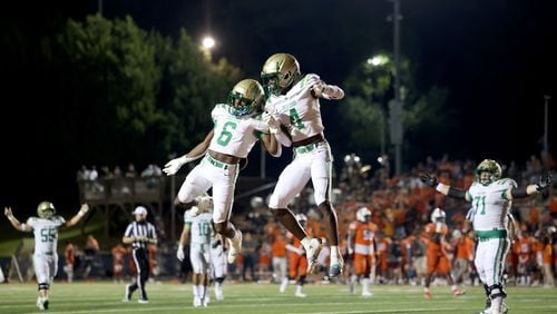 August 20, 2021 - Kennesaw, Ga: Buford wide receiver Tobi Olawale (4) celebrates his receiving touchdown with running back Victor Venn (6) during the second half against North Cobb at North Cobb high school Friday, August 20, 2021 in Kennesaw, Ga.. Buford won 35-27. JASON GETZ FOR THE ATLANTA JOURNAL-CONSTITUTION