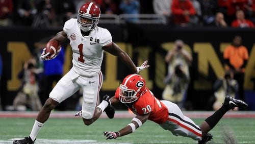 Robert Foster #1 of the Alabama Crimson Tide stiff arms J.R. Reed #20 of the Georgia Bulldogs on a run durign the first quarter in the CFP National Championship presented by AT&T at Mercedes-Benz Stadium on January 8, 2018 in Atlanta, Georgia.  (Photo by Mike Ehrmann/Getty Images)
