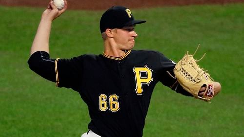 This April 24, 2017 file photo shows Pittsburgh Pirates relief pitcher Dovydaus Neverauskas from Lithuania makes his Major League debut in the eighth inning of a baseball game against the Chicago Cubs in Pittsburgh. The 24-year-old flamethrowing reliever is the first player from Lithuania to play in the MLB. The Cubs won 14-3. (AP Photo/Gene J. Puskar)