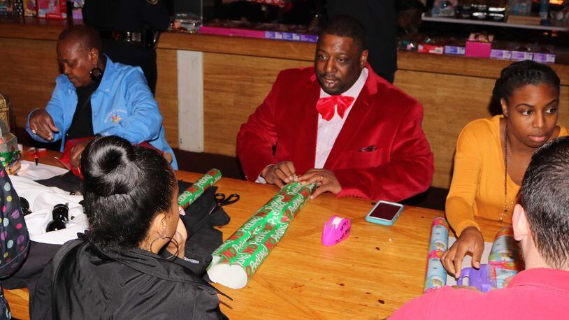 The gift wrapping event from the annual “Dads, Daughters, and Dolls” drive in December 2016.