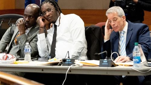 Atlanta rapper Young Thug listens in on a bench meeting between the judge and another attorney before the opening statements in his Fulton County gang and racketeering trial on Monday.