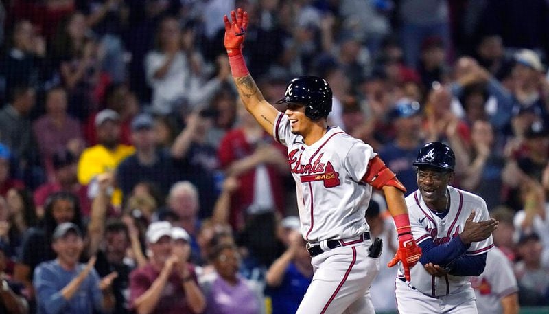 The Braves' Vaughn Grissom celebrates while running the bases on his two-run home run against the Red Sox during the seventh inning Wednesday in Boston. At right is Braves third-base coach Ron Washington. (AP Photo/Charles Krupa)