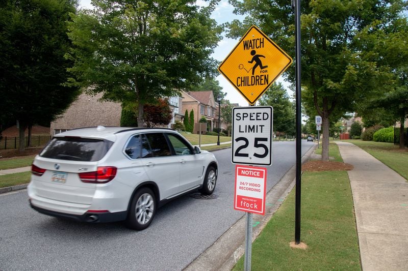 A car approaches a sign notifying drivers their license plates are being recorded as they drive into the McGinnis Reserve community Monday, July 29, 2019. STEVE SCHAEFER / SPECIAL TO THE AJC