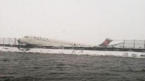 Delta Air Lines Flight 1086 is seen after it slid off the runway upon landing at New York's LaGuardia Airport March 5, 2015. The Delta Air Lines jetliner landing during a snowstorm at New York's LaGuardia Airport on Thursday slid off the runway and struck a fence before coming to rest at the edge of Flushing Bay, but there were no serious injuries.