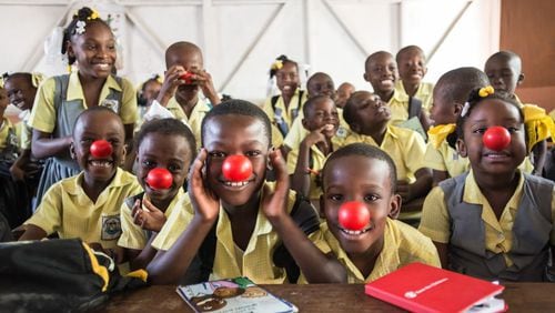 Red Nose Day has raised more than $1 billion since 1988 to help children worldwide stay healthy, safe and educated. Here, Haitian students show off their red noses after receiving a grant.