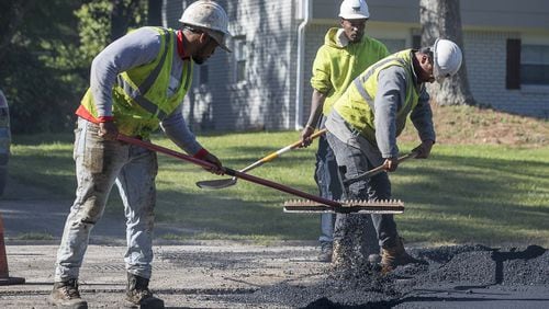 04/16/2020 - Decatur, Georgia - An H.E.H. Paving crew works to lay asphalt on Gwendon Terrace in Decatur, Thursday, April 16, 2020. The paving project is part of the DeKalb County Special Purpose Local Option Sales Tax or SPLOST. (ALYSSA POINTER / ALYSSA.POINTER@AJC.COM)