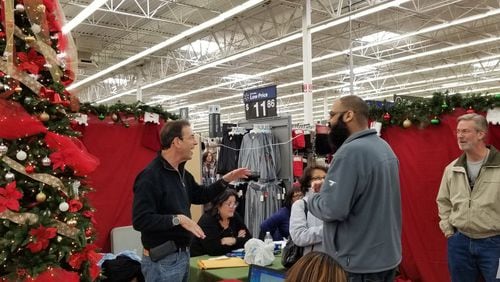 Consumer advocate Clark Howard, left, was collecting gifts for Clark's Christmas Kids Saturday at Walmart in Duluth. This is the 27th year for the charity, which provides gifts for Georgia children in foster care. (Twitter photo from John Berry, St. Vincent de Paul of Georgia, @SVDPGA)