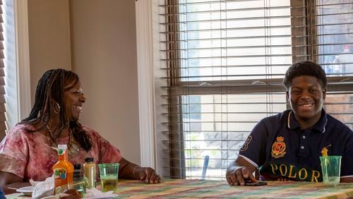 Samanthia Jordan-Hill jokes with her adopted son, Christian Jordan, at their residence in Newnan.  (Alyssa Pointer / Alyssa.Pointer@ajc.com)