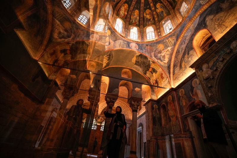 A visitor takes photographs during her visit to a former Byzantine church which formally opened as a mosque, in Istanbul, Turkey, Monday, May 6, 2024. Turkish President Recep Tayyip Erdogan formally opened a former Byzantine church in Istanbul as a mosque on Monday, four years after his government had designated it a Muslim house of prayer, despite criticism from neighboring Greece. (AP Photo/Emrah Gurel)
