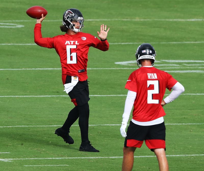 Falcons backup quarterback Kurt Benkert completes a pass with Matt Ryan looking on during training camp Saturday, Aug. 15, 2020, in Flowery Branch. (Curtis Compton ccompton@ajc.com)