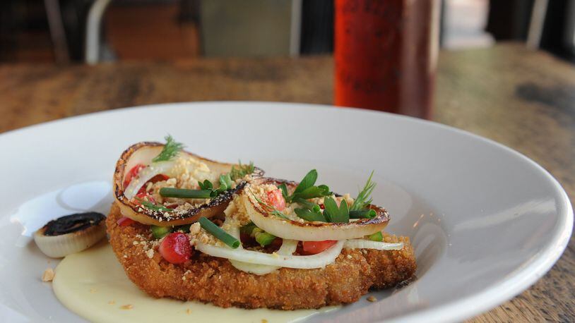 Pork loin schnitzel with “quickled” peaches and strawberries, jalapeno, charred sweet onion, peanuts, herbs and Gouda fonduta pictured with a Gate City Copperhead amber ale. (BECKY STEIN PHOTOGRAPHY)