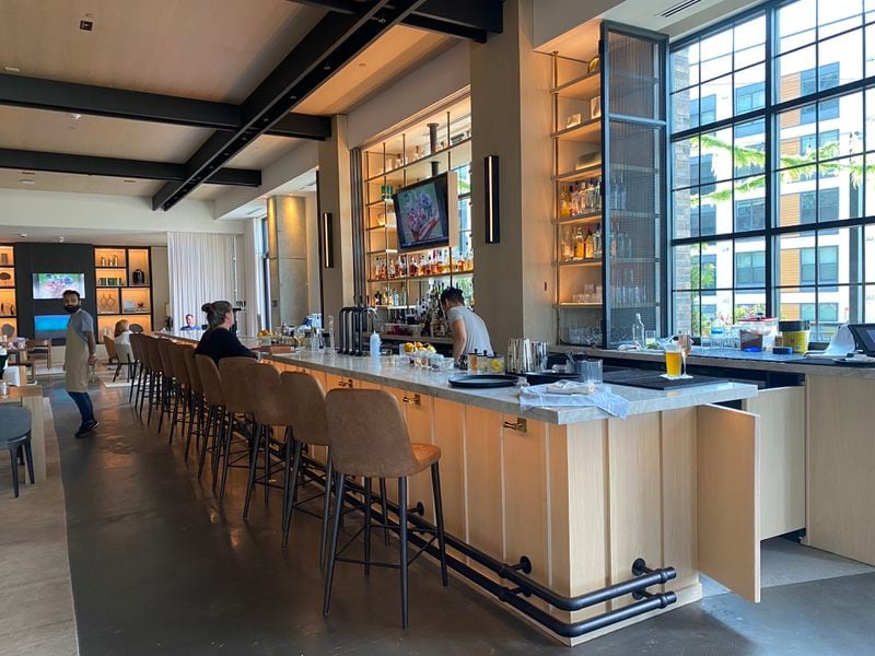 The interior of Drawbar, the new restaurant at the Bellyard Hotel in West Midtown, has high, industrial ceilings and plenty of elbow room. (Ligaya Figueras / ligaya.figueras@ajc.com)