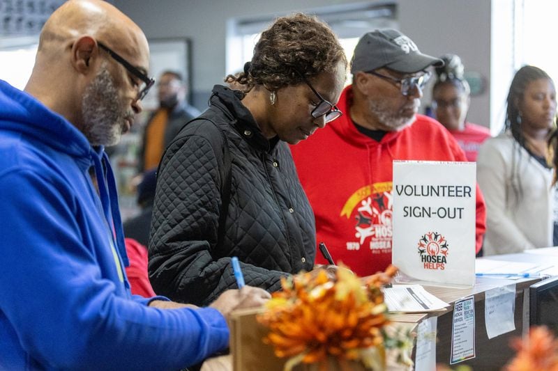  Volunteers register before assembling the hot meals Hosea Helps delivers to people around Atlanta on Thursday, November 23, 2023.  (Steve Schaefer/steve.schaefer@ajc.com)