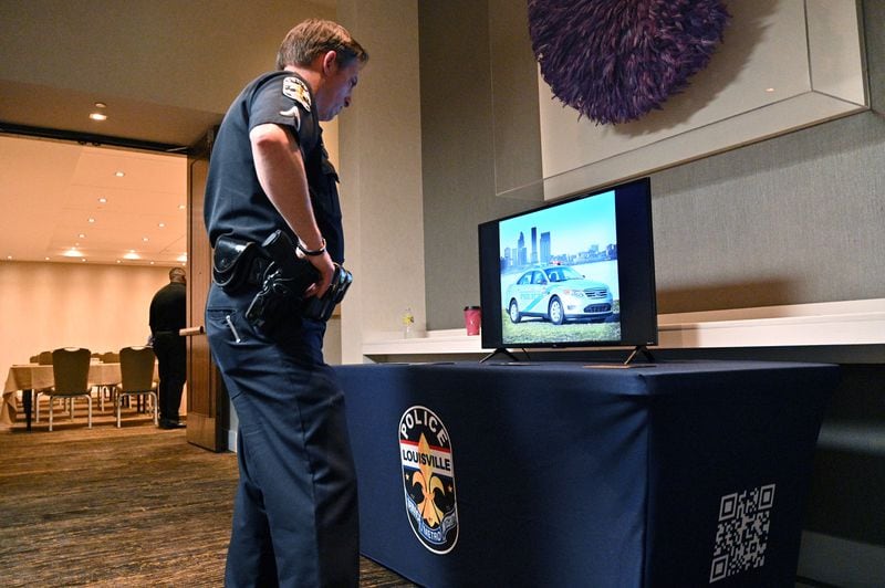 March 24, 2022 Atlanta - A recruiter from Louisville Metro Police watches a promotional video as he and other recruiters wait for potential recruits during their recruiting event at Hyatt Centric Midtown Atlanta on Thursday, March 24, 2022. (Hyosub Shin / Hyosub.Shin@ajc.com)