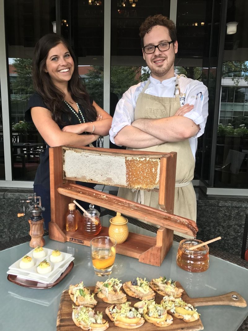 David Bartlett, executive chef of Southern Art and Bourbon Bar, stands next to his honey luge. With him is Madeline Sims, event coordinator for Taste of Atlanta. CONTRIBUTED BY DAVID BARTLETT