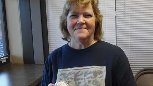 Linda Ruth shows off signed baseball at Gwinnett Braves game Monday.