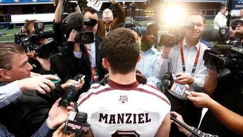 Former Texas A&M quarterback Johnny Manziel surrounded by members of the media. (Richard W. Rodriguez/Fort Worth Star-Telegram/MCT)