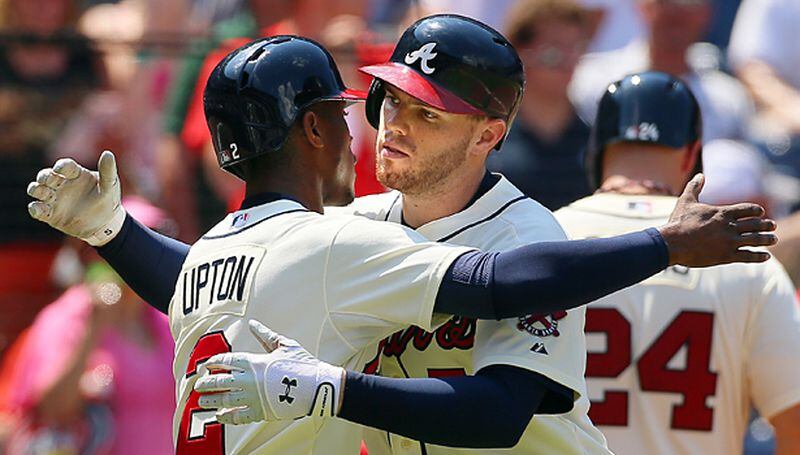 After sharing the offensive load with the likes of Justin Upton in 2014, Freeman was the centerpiece of the offense in 2015, and despite getting little protection in the lineup he produced impressive statistics before he got hurt. (Curtis Compton/AJC photo) 081113 Atlanta: Braves Freddie Freeman gets a hug from B.J. Upton crossing home plate after hitting a 3-RBI home run for a 4-3 lead over the Marlins in the fifth inning of their MLB baseball game on Sunday, August 11, 2013, in Atlanta. The Braves went on to beat the Marlins 9-4. CURTIS COMPTON / CCOMPTON@AJC.COM