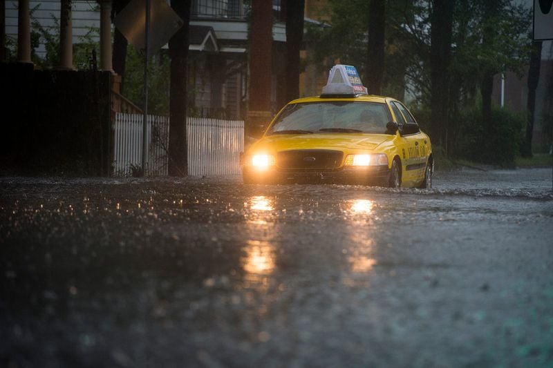 A taxi attempts to cross the flooded intersection of Martin Luther King Jr. Blvd. and Victory Drive Friday afternoon as Hurricane Matthew hits the coast of Georgia in 2016. The intersection expects to be prone to flooding this week due to the impact of Hurricane Ian.