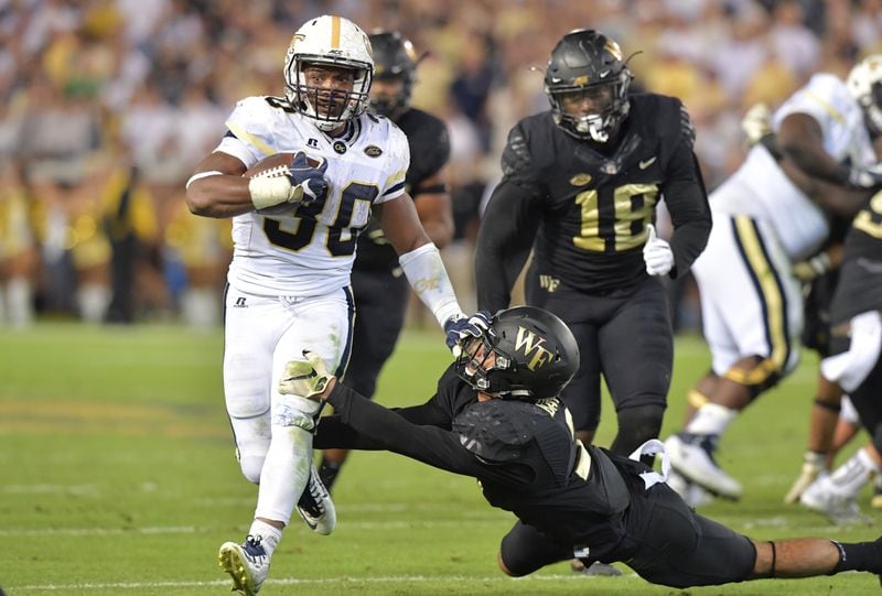 Georgia Tech running back KirVonte Benson (30) eludes a tackle by Wake Forest defensive back Jessie Bates III (3) in the first half of an NCAA college football game at Bobby Dodd Stadium on Saturday, October 21, 2017. HYOSUB SHIN / HSHIN@AJC.COM