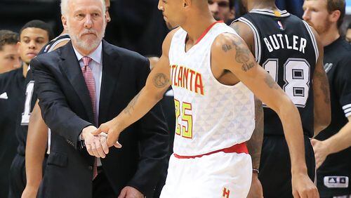 101415 ATLANTA: Spurs head coach Gregg Popovich gives Hawks guard Thabo Sefolosha a hand shake during a time out in the first half in their preseason basketball game on Wednesday, Oct. 14, 2015, in Atlanta. It is Sefoloshaâ€™s first game back since being injured in a Manhattan night club last season. Curtis Compton / ccompton@ajc.com