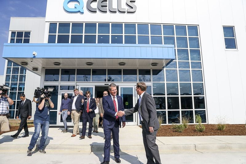 Dalton, Georgia — Gov. Brian Kemp is greeted after finishing a tour of the Hanwha Q Cells solar manufacturing facility in Dalton a few years ago. The plant is billed as the largest solar panel assembly plant in the Western Hemisphere. (Alyssa Pointer/alyssa.pointer@ajc.com)