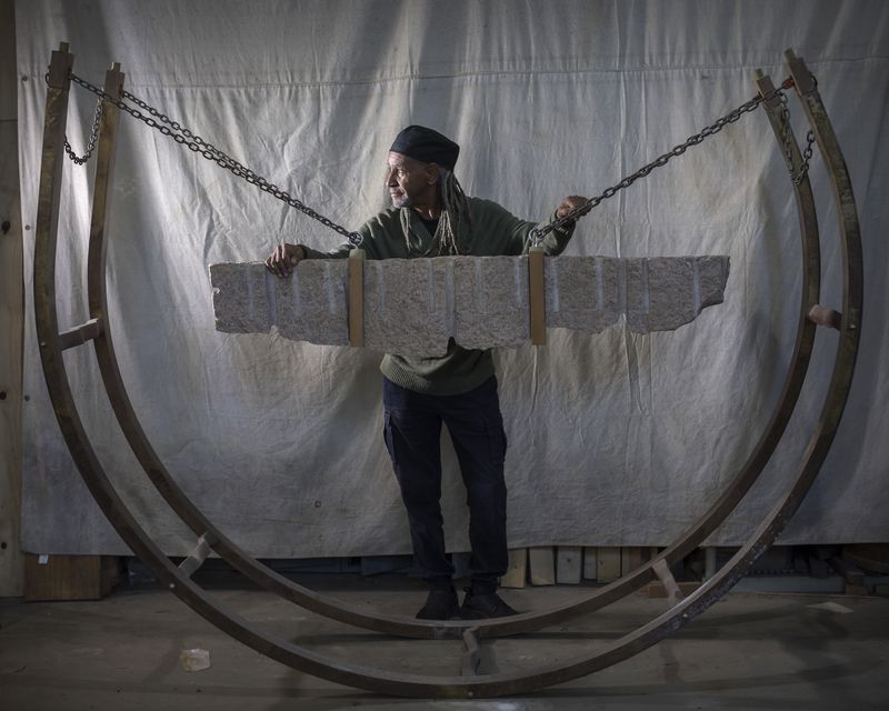 SAVANNAH, GA - FEBRUARY 07, 2024: Jerome Meadows is a sculpture, world-renowned for his public arts projects, stands behind his granite and bronze rocker piece titled, "The Rhythm of the Rock", at his studio, Wednesday, Feb. 7, 2024, in Savannah, Ga. (AJC Photo/Stephen B. Morton)
