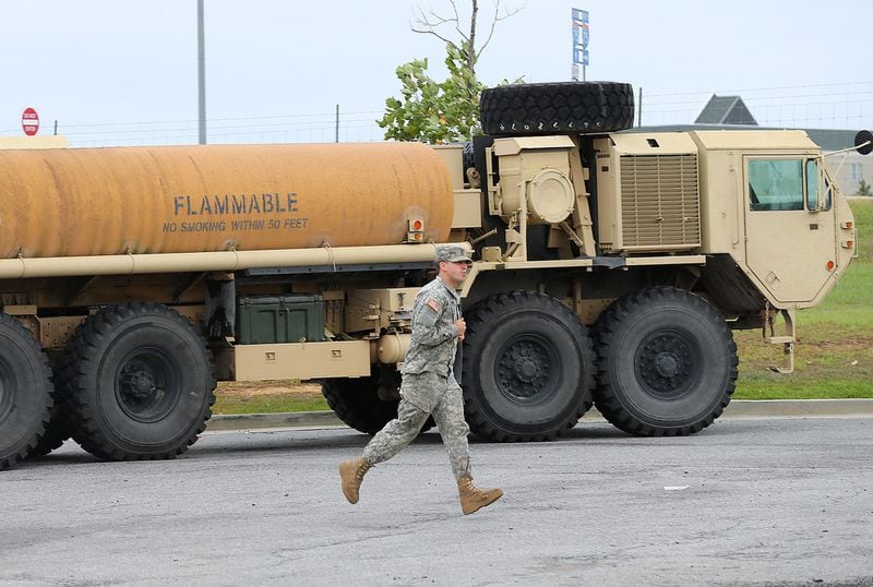 September 10, 2017 Cordele: A Georgia National Guard soldier runs past his fuel truck as his unit scrambles to get to a staging area off I-75 North with Hurricane Irma approaching on Sunday, September 10, 2017, in Cordele. Curtis Compton/ccompton@ajc.com