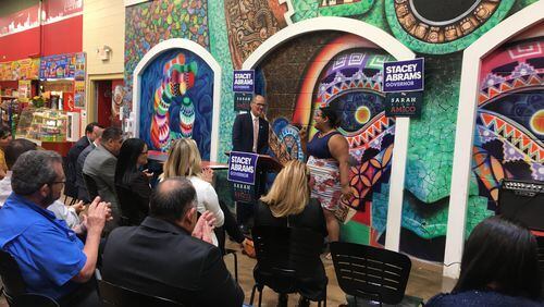 Democratic National Committee Chairman Tom Perez (left) and Genny Castillo, Latinx constituency director for the Coordinated Campaign of the Georgia Democratic Party, address Hispanic voters and candidates at Plaza Fiesta on Buford Highway on Wednesday, Aug. 15, 2018.