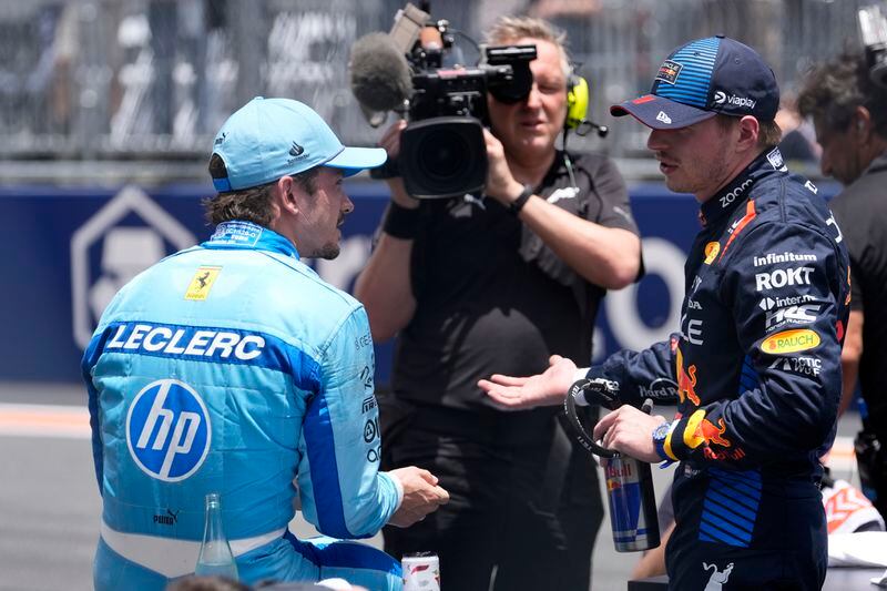 Ferrari driver Charles Leclerc, of Monaco, left, and Red Bull driver Max Verstappen, of the Netherlands, right, talk after the Sprint race at the Miami Formula One Grand Prix, Saturday, May 4, 2024, in Miami Gardens, Fla. (AP Photo/Lynne Sladky)