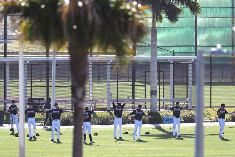 Braves pitchers loosen up in the early morning light on the agility field getting ready for another day of spring training at CoolToday Park on Saturday, Feb. 27, 2021, in North Port.   Curtis Compton / Curtis.Compton@ajc.com”