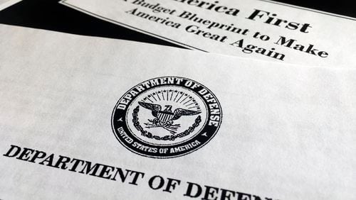 A portion of President Donald Trump's first proposed budget, focusing on the Department of Defense, and released by the Office of Management and Budget, is photographed in Washington, Wednesday, March 15, 2017. President Donald Trump is unveiling a $1.15 trillion budget, a far-reaching overhaul of federal government spending that slashes a dozen departments to finance a significant increase in the military and make a down payment on a U.S.-Mexico border wall. (AP Photo/Jon Elswick)