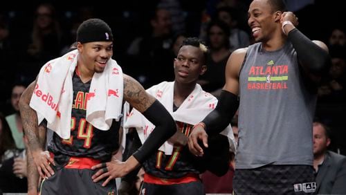 Atlanta Hawks’ Kent Bazemore, left; Dennis Schroder, center, and Dwight Howard, right, smile during the second half of the team’s NBA basketball game against the Brooklyn Nets on Tuesday, Jan. 10, 2017, in New York. The Hawks won 117-97. (AP Photo/Frank Franklin II)