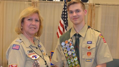 Ute Whatley congratulates Preston Anderson on becoming an Eagle Scout. Earlier this month, he became the 1,000th Boy Scout that Whatley has helped reach that achievement. CARL LOWRY