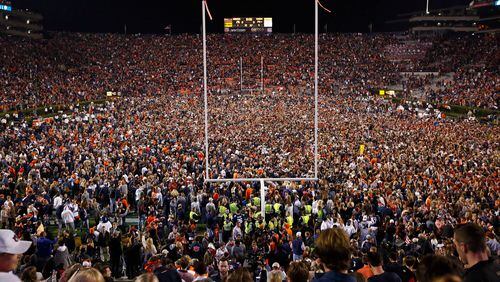 Fans rush the field after Auburn defeated Alabama in the Iron Bowl.