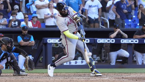 Atlanta Braves' Marcell Ozuna hits a home run scoring Ronald Acuña Jr. and Matt Olson during the ninth inning of a baseball game against the Miami Marlins, Sunday, April 14, 2024, in Miami. (AP Photo/Wilfredo Lee)