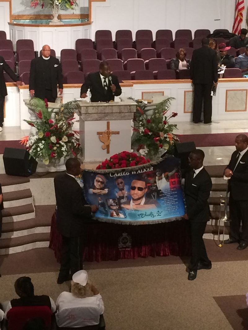 Ushers display a prayer shawl before presenting it to Shawty Lo's mother at the Saturday funeral service. Photo: Jennifer Brett